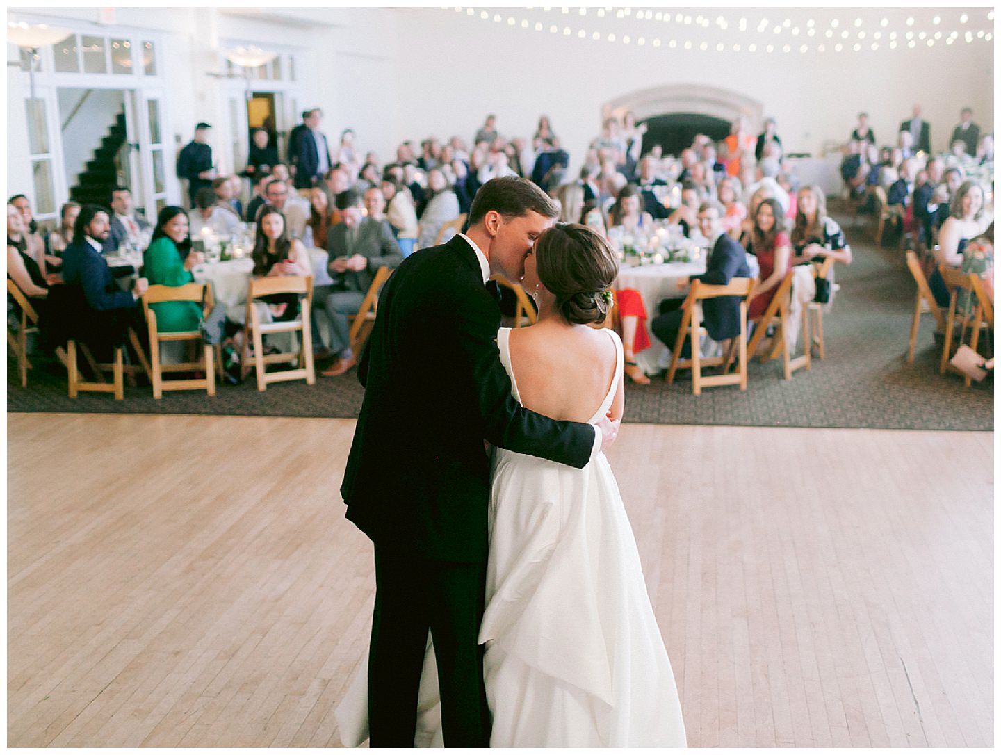 bride and groom kiss at golden gate club reception
