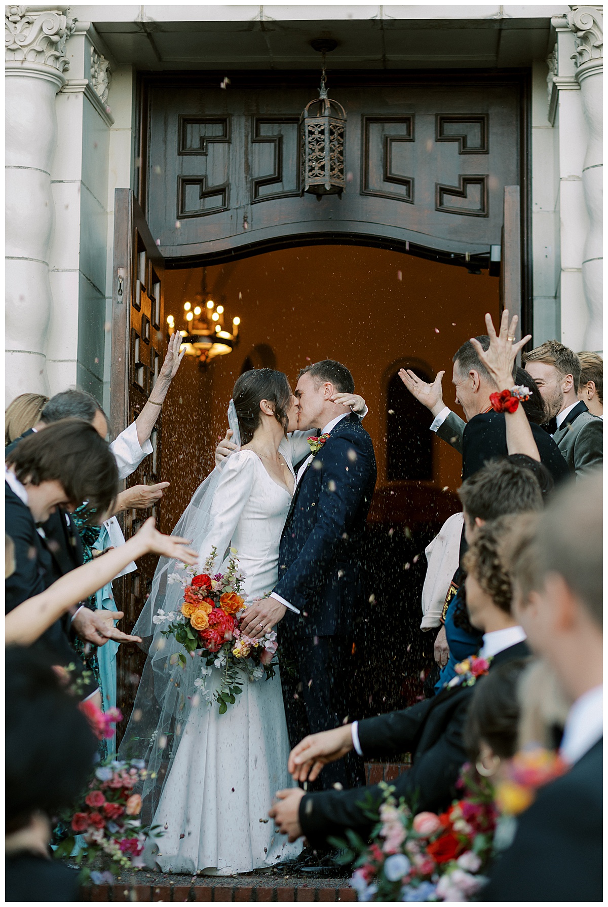 flower petal toss at bride and groom post wedding ceremony 