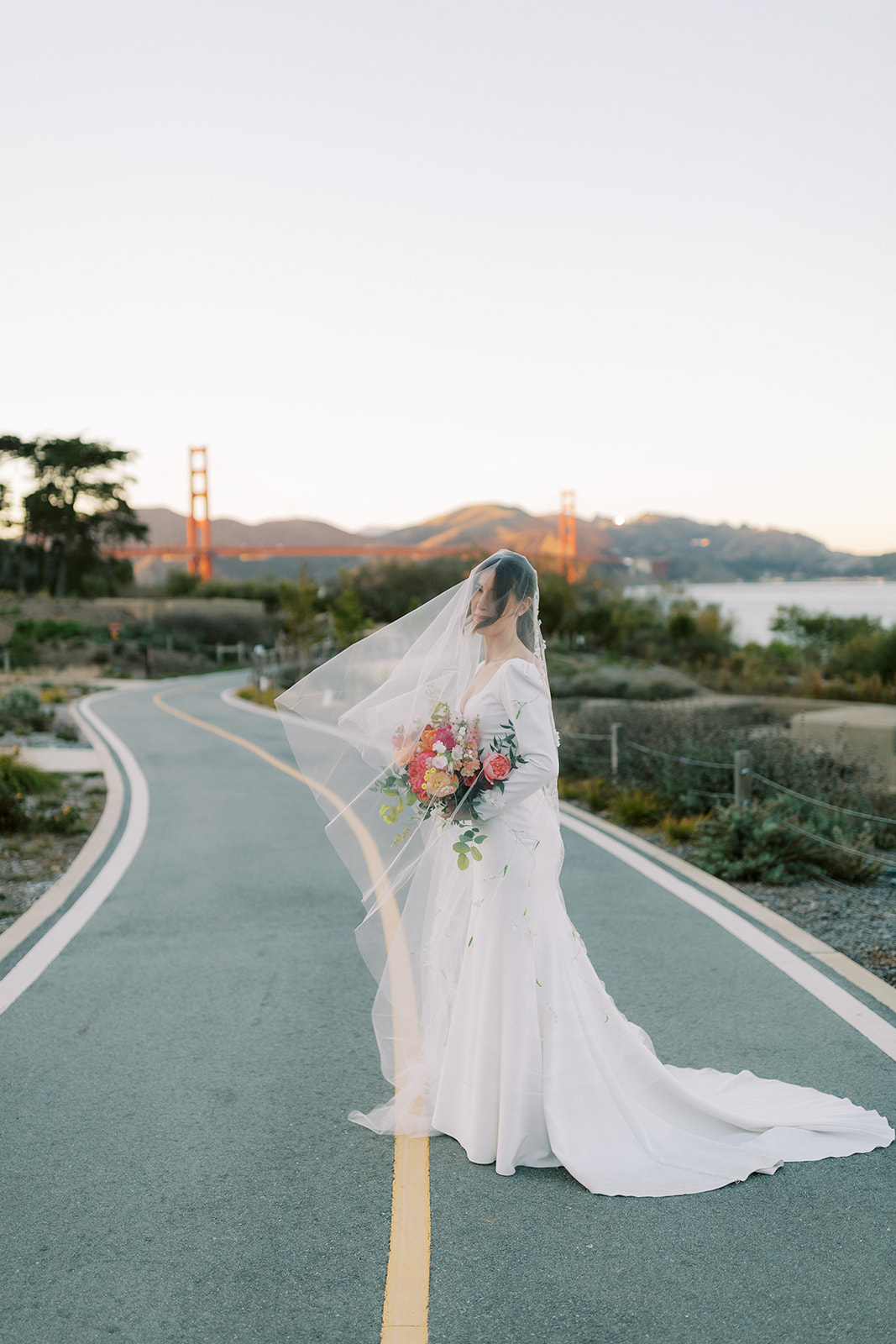 bride standing in front of the Golden Gate Bridge under the veil
