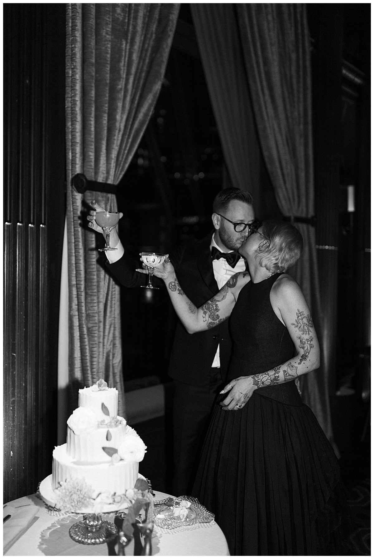 black and white photo of couples cake cutting at Julia Morgan ballroom