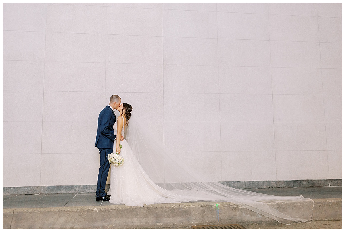 couple kissing against wall
