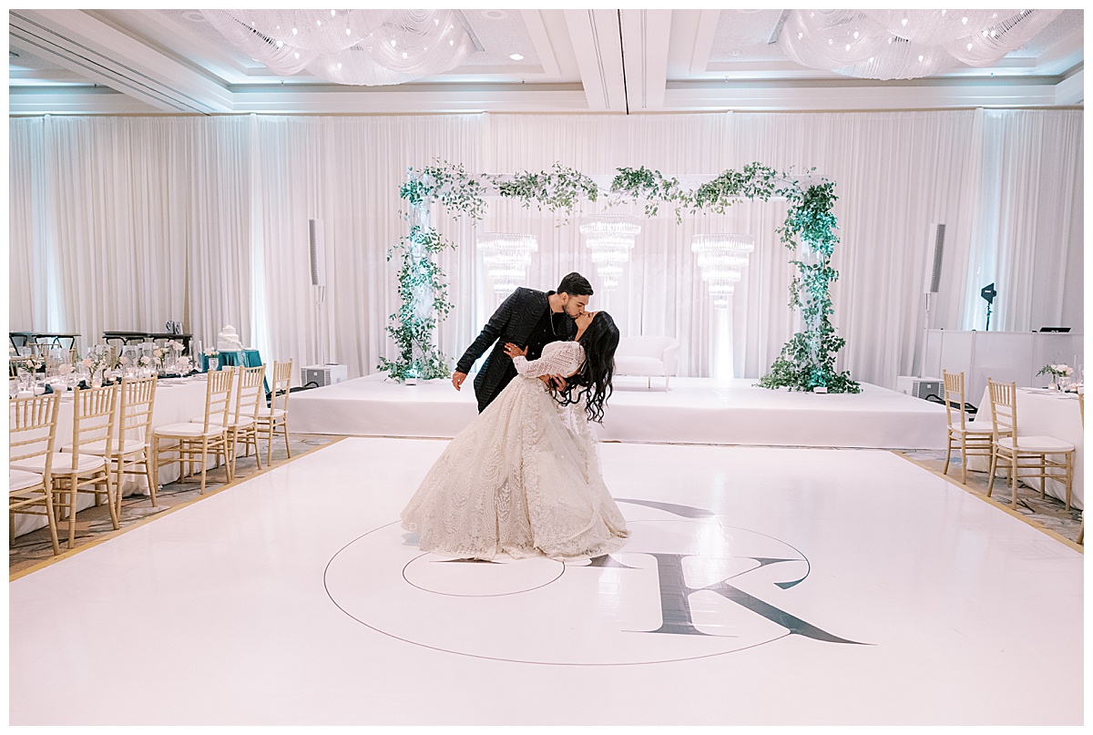groom dips bride in the center of dance floor at Hyatt sfo