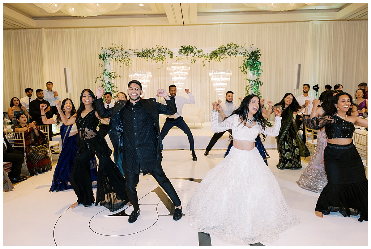Group of friends and family doing a choreographed dance at at Westin SFO Indian Wedding reception.
