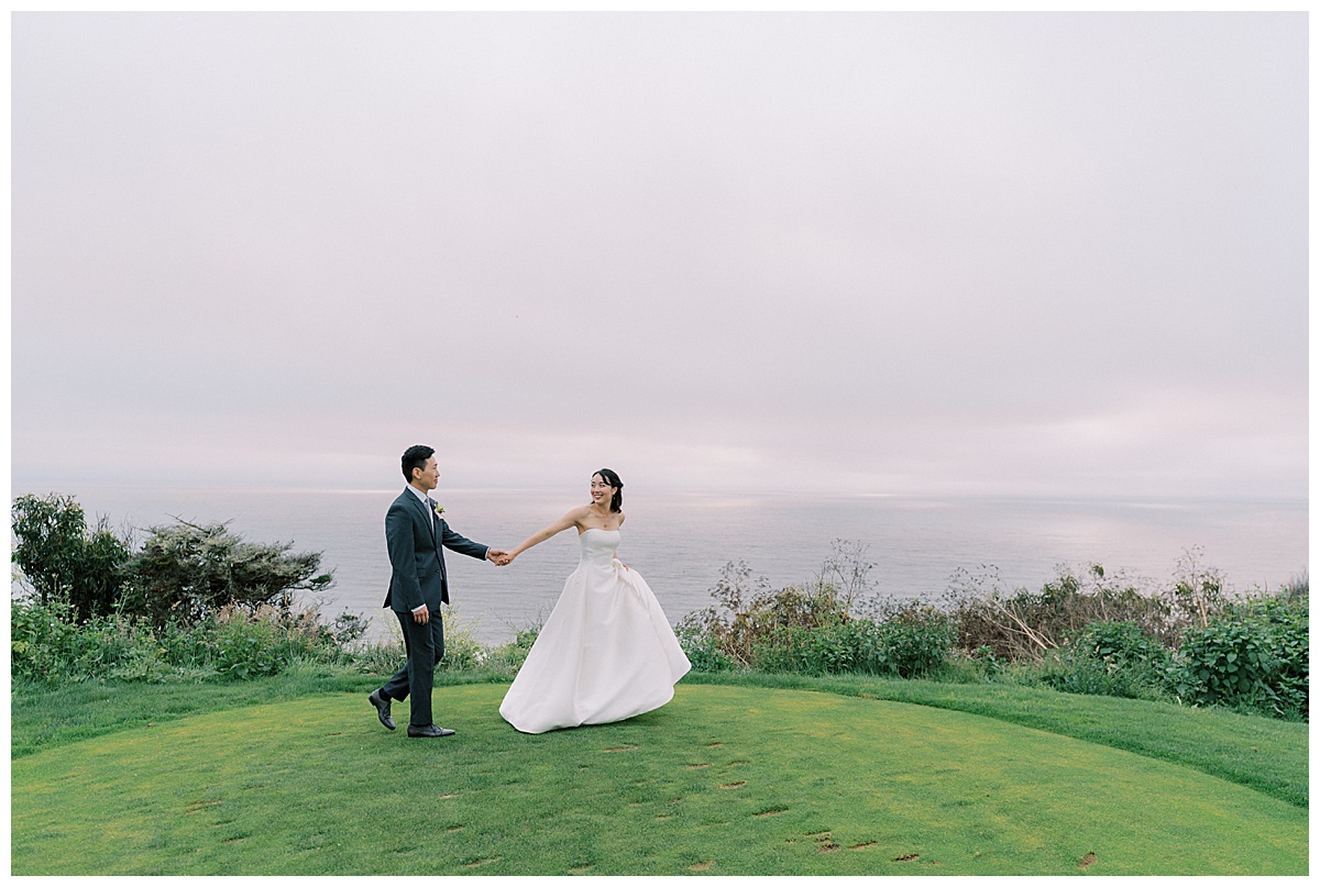 bride leading groom across lawn at the olympic club on their wedding day