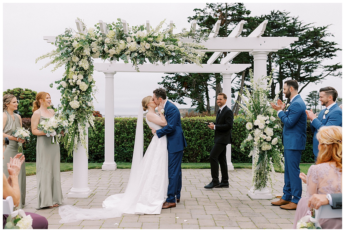 wide photo of couples first kiss at oceano hotel and spa in half moon bay