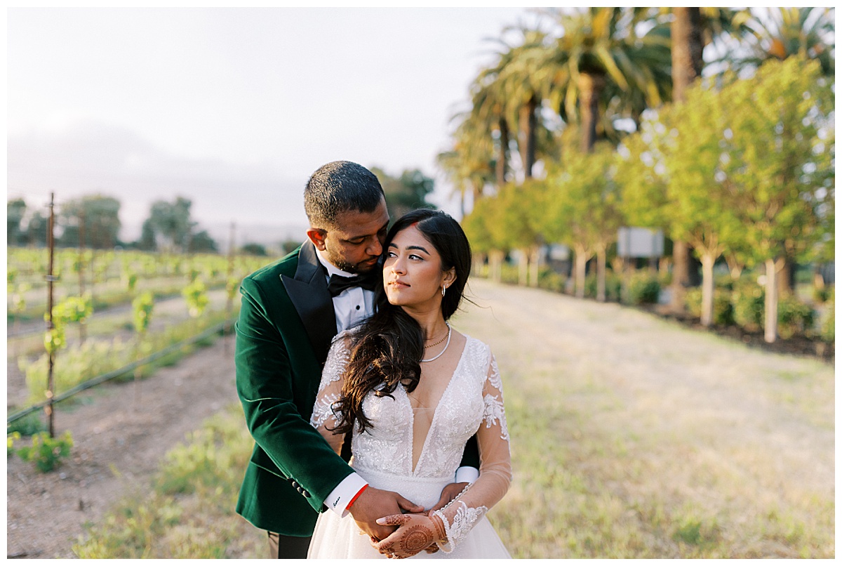 indian couple embracing outside of vines at palm event center