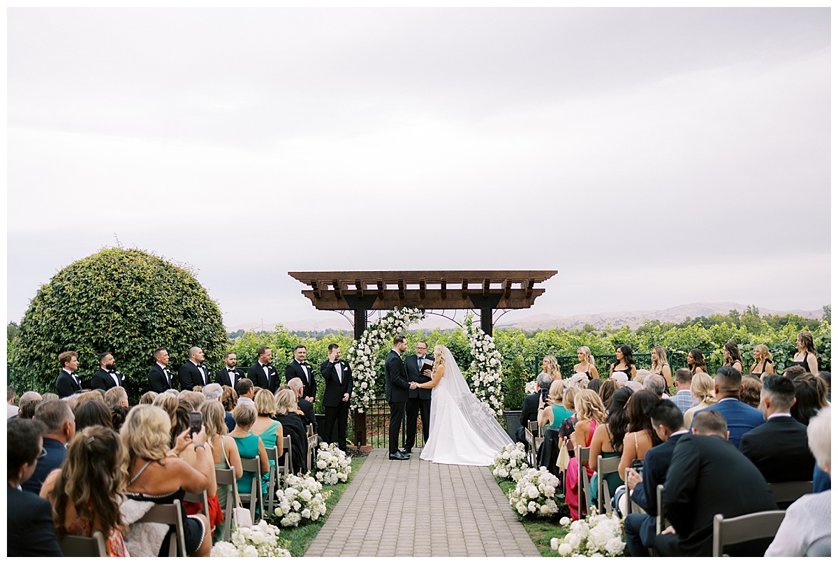 wide photo of couples wedding ceremony at palm event center