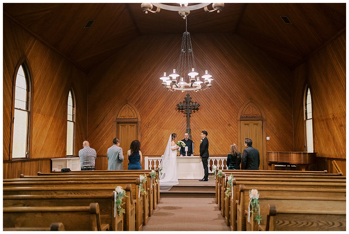 wide photo of a ceremony at old st Hilarys