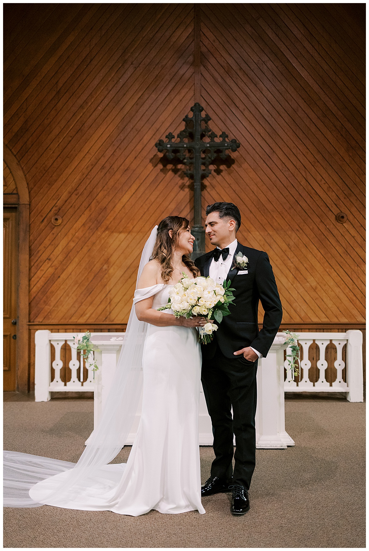 newlywed couple sharing private smile moment at the alter after old st. Hilary's elopement ceremony