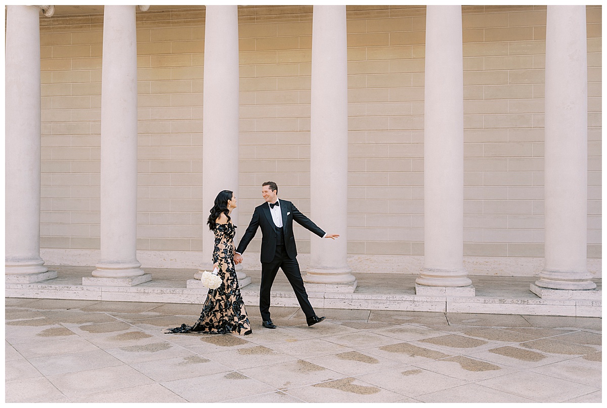 wide photo of elegantly dressed bride and groom walking at legion of honor in San Francisco 