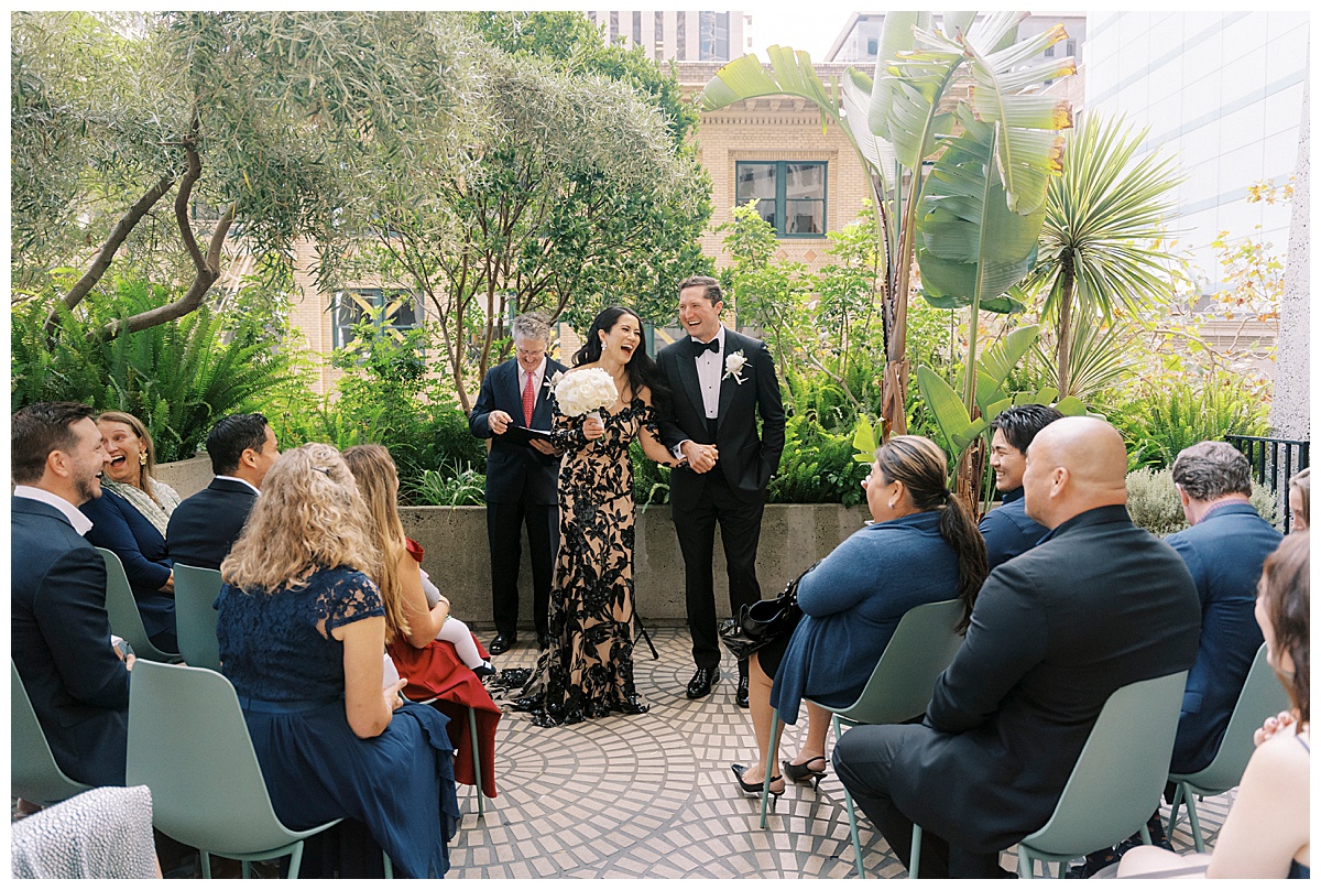 bride and groom celebrating in laughter on the rooftop at plant connection sf