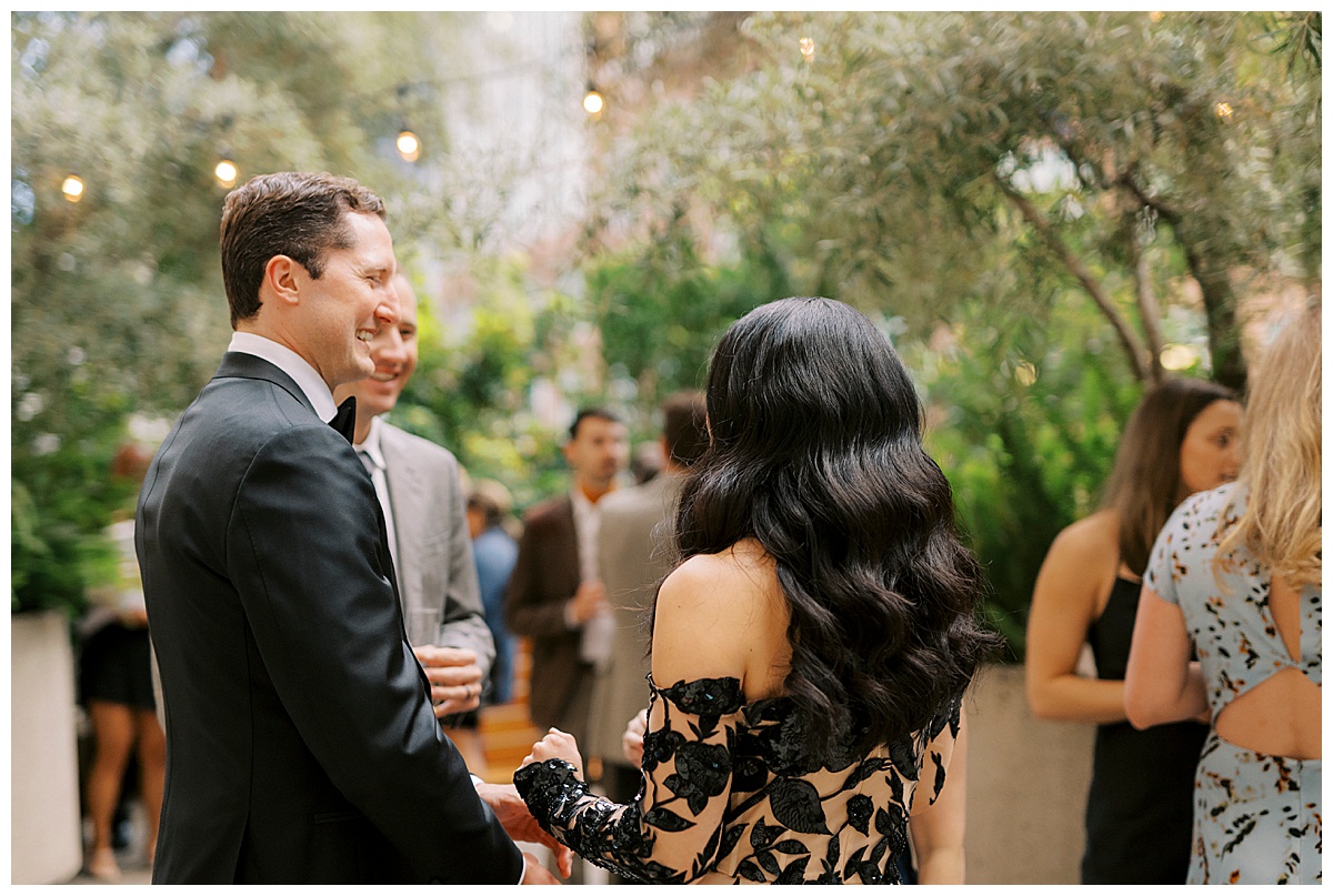 bride and groom laughing with guests during their cocktail hour at plant connection sf