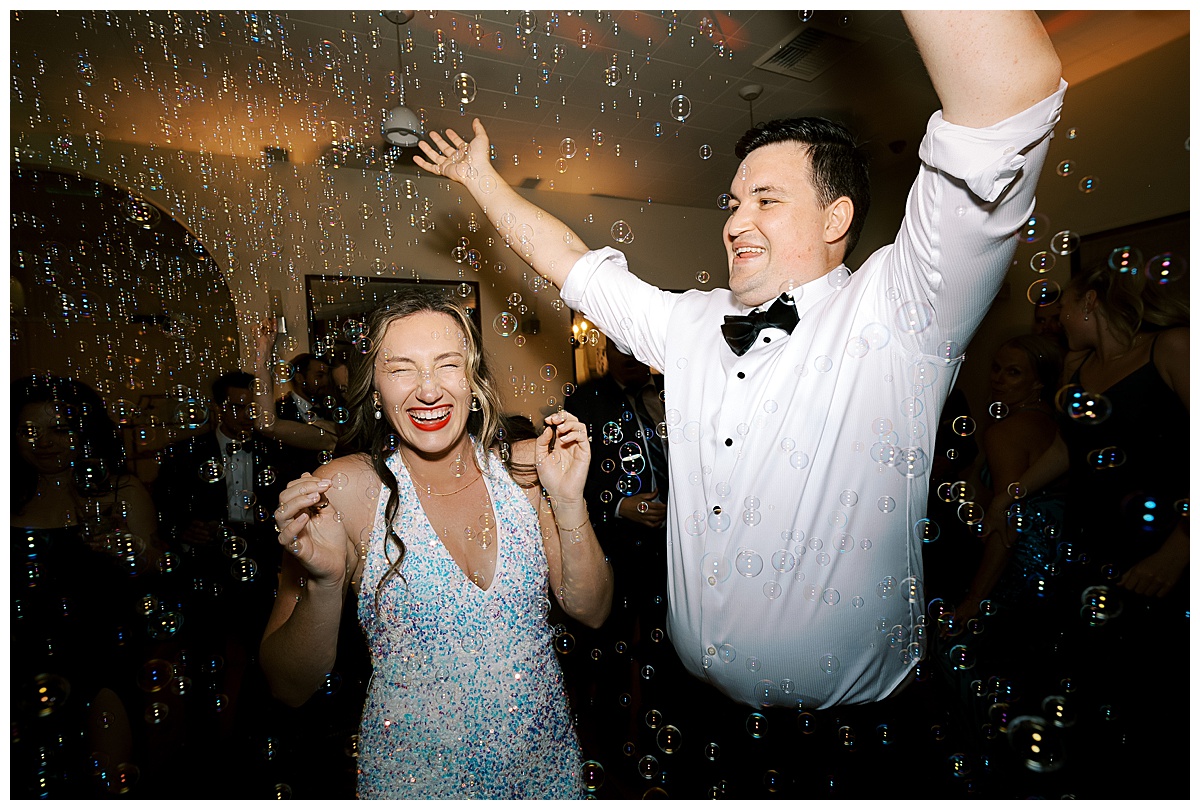 couple dancing in room full of bubbles at their reception at villa and vine