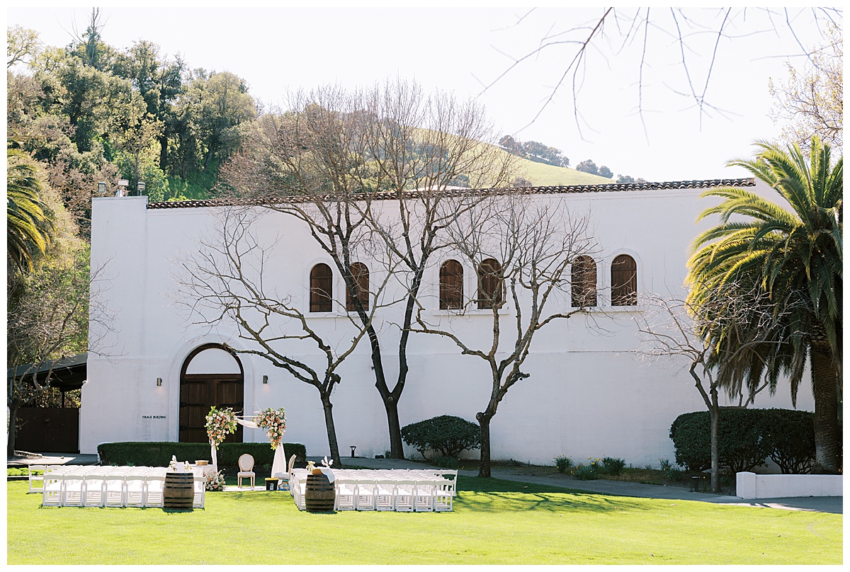Wide photo of ceremony set up outside of Wente vineyards tasting lounge
