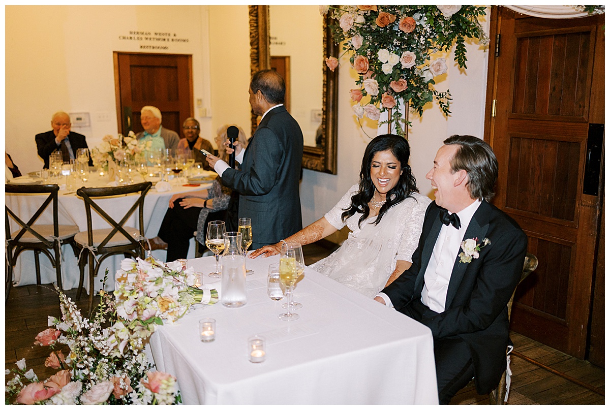 couple laughing at wedding reception