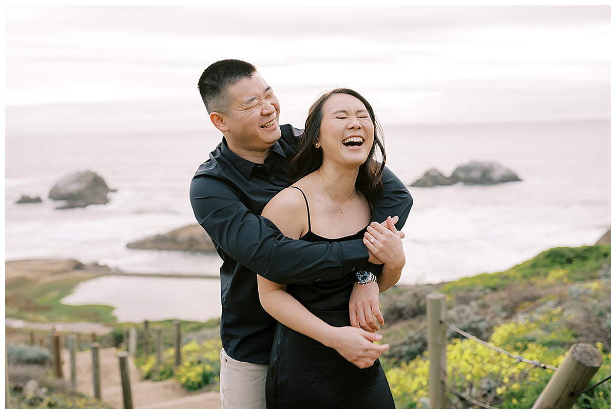 couple laughing together at sutro baths during engagement session