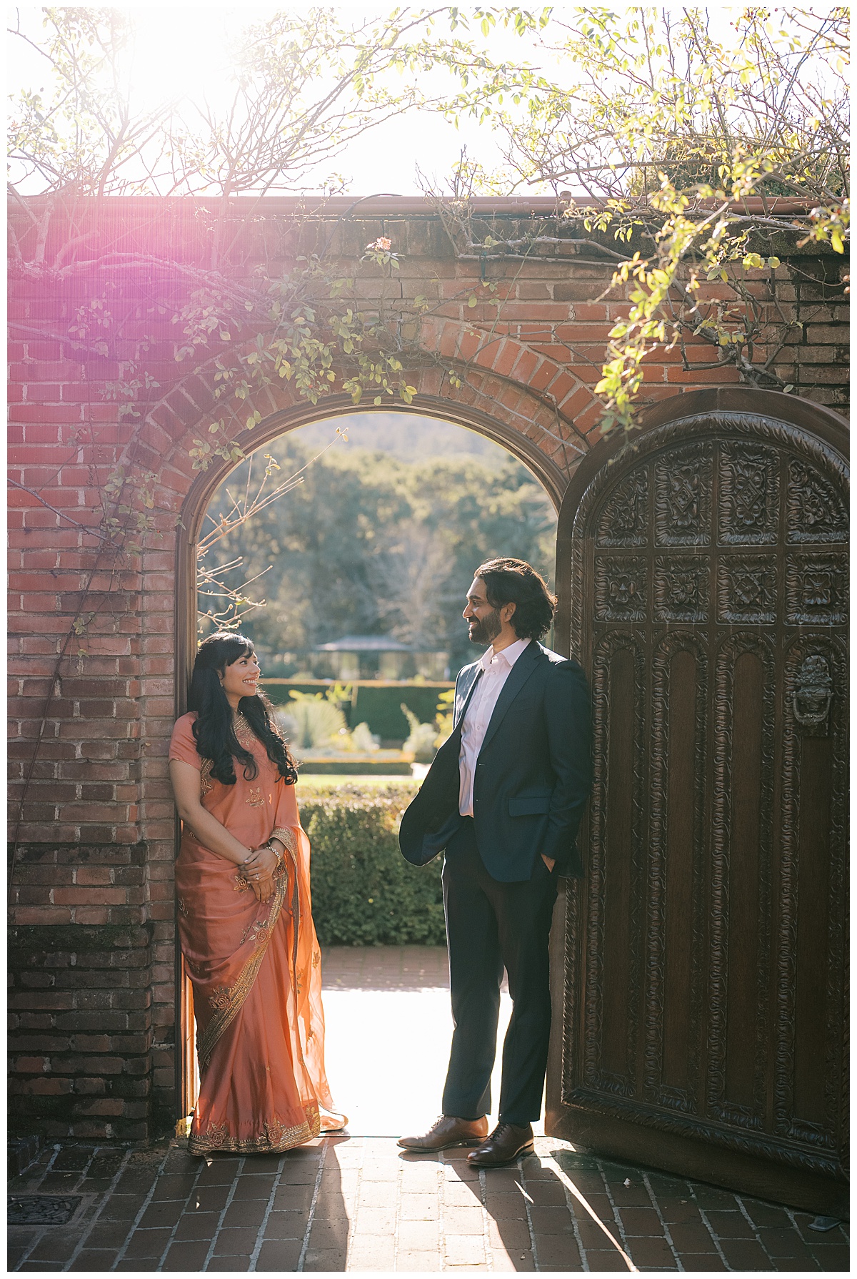 couple standing in arch at filoli gardens during engagement photos