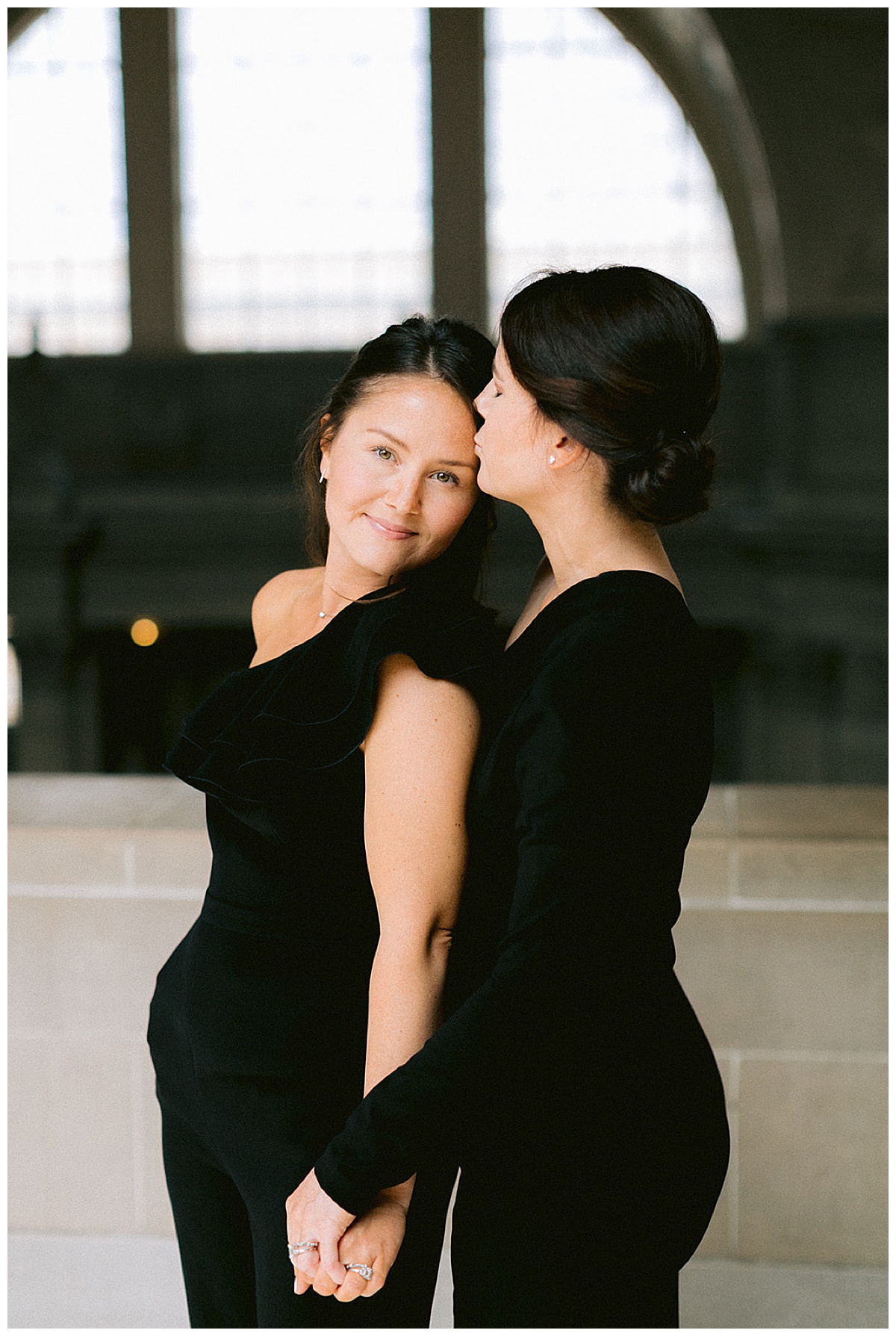 lesbian couple in black dresses at city hall