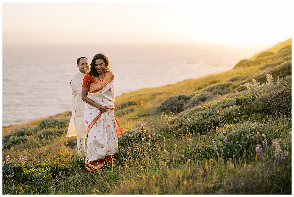 INDIAN COUPLE WALKING ON CLIFFS AT RODEO BEACH