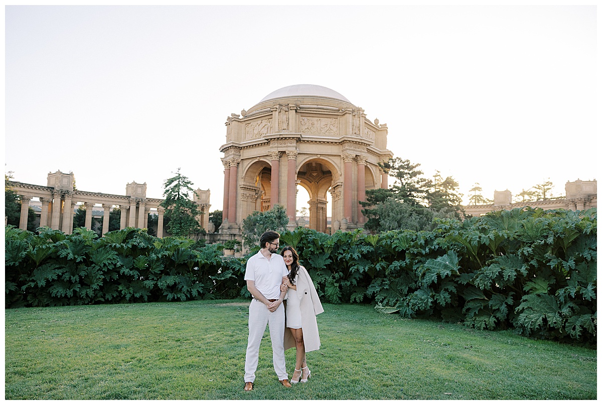 couple standing in front of the palace of fine arts during engagement photoshoot