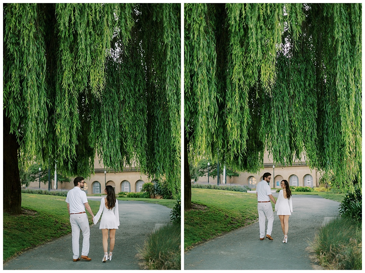 couple walking under tree at palace of fine arts