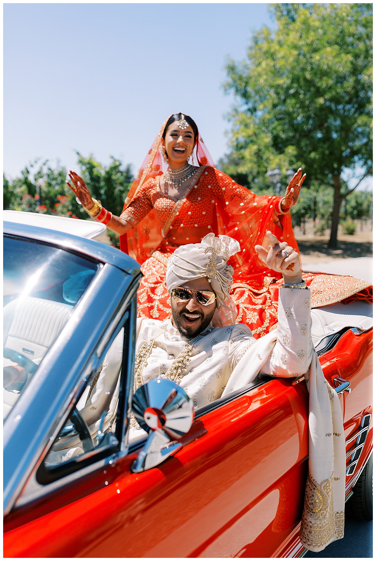 Bay Area Indian wedding couple in a red convertible after ceremony